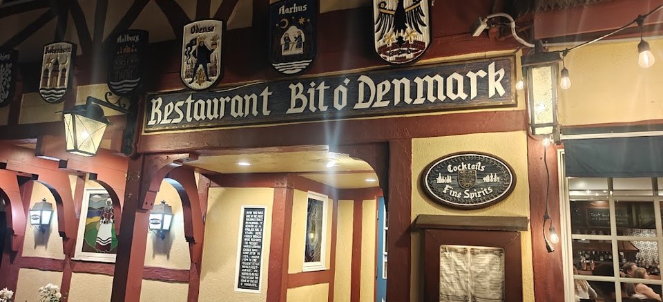 Printed menu featuring entrées, sandwiches, and desserts.